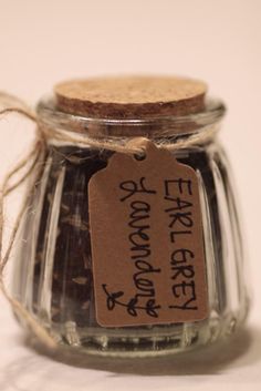 a glass jar with some kind of food in it and a tag on the lid