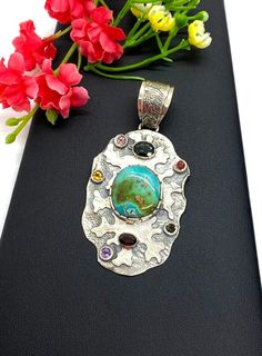 "ARTISAN TURQUOISE TOURMALINE PENDANT Hand-made Sterling Silver 925. Stones used: Turquoise(Nevada), Green Tourmaline, Pink Tourmaline, Red Sapphire, Citrine, Amethyst, Garnet. Height -2 3/4\" (including bail), Width - 1 6/16\" Height - 72mm (including bail), Width - 35mm Unique Handcrafted One-of a-kind Design Pendant Each Piece of Jewelry in my Collection is Absolutely One of a Kind! When you start wearing a piece of my jewelry you will fall in love with it more and more each day and feel that Artisan Turquoise Necklace With Stones As Gift, Artisan Turquoise Stone Necklace, Artisan Turquoise Stones Necklace For Gift, Unique Multi-stone Turquoise Gemstones, Handmade Multicolor Sterling Silver Turquoise Necklace, Handmade Artisan Turquoise Gemstones, Turquoise Multi-stone Pendant Necklace As Gift, Unique Turquoise Stone Pendant Necklace, Unique Turquoise Pendant Necklace