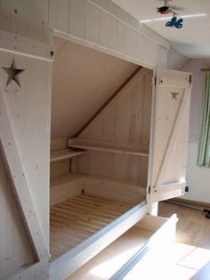 an image of a bed in the middle of a room that has been converted into a loft