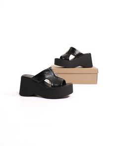 The Zip-Hop Platform Sandal is the perfect shoe for the fashion-forward woman who wants a stylish and comfortable shoe. The 3.5-inch platform wedge heel is modern and sexy, while the slip-on entry makes it easy to wear. The lightly padded footbed ensures hours of comfort, and the zipper detailing on the upper adds a touch of edgy appeal. Best of all, the Zip-Hop Platform Sandal is lightweight! Manmade Materials l 3.5" Platform Wedge l True to Size Leather Platform Slippers With Wedge Heel, Black Wedge Heel Platform Slippers For Spring, Black Platform Wedge Sandals For Spring, Black Leather Wedge Heel Platform Slippers, Trendy Leather Wedge Sandals With Thick Sole, Black Open Toe Platform Wedge Sandals, Summer Leather Platform Heels, Trendy Leather Wedge Sandals With Thick Bottom, Black Platform Wedge Sandals With Open Toe