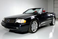 a black convertible car parked in a garage