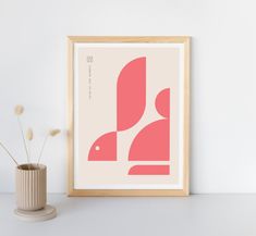 an art print is displayed next to a vase