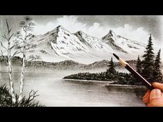 a person is holding a pencil in front of a drawing of a mountain lake and trees