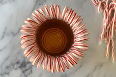 candy canes in a bowl on a marble table