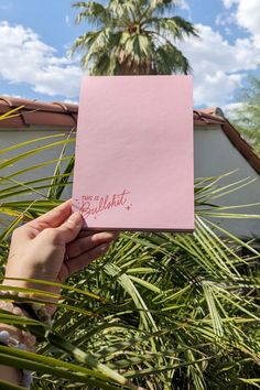 bobo design studio's This is BS Notepad held up with palm springs in the background