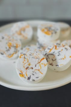 some white and orange desserts are on a plate