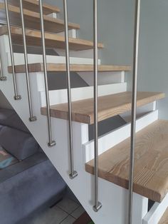 a set of stairs with wooden treads and metal handrails in a living room