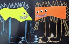 two children's drawings on a blackboard with colored crayons