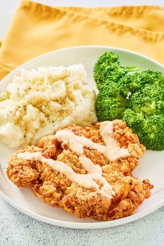 chicken, broccoli and mashed potatoes on a plate with gravy