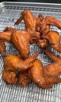 fried chicken wings on a cooling rack ready to be cooked in the oven for consumption