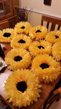 sunflowers are laid out on a table to be used as centerpieces