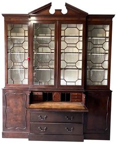 an old china cabinet with glass doors and drawers on it's sides, against a white background