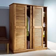 an armoire with wooden shutters in a room