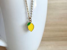 This dainty lemon necklace is made of the following: (1) gold plated yellow and green epoxy lemon charm (13.5 x 9mm) (2) gold plated or 14KGF chain ✏️ Please choose your desired plating of chain ✏️ Please choose the length of the chain (the length includes clasp and findings). ❣️ If you are unsure about which length to choose , please leave me a note to request an extension chain to be added to the chain at check out. 🍋 EARRINGS 🍋 https://www.etsy.com/listing/1036952369 【BEFORE PURCHASE, PLEAS Dainty Yellow Necklace For Gift, Dainty Yellow Necklace For Gifts, Dainty Yellow Charm Necklace For Gifts, Cute Yellow Necklace For Gift, Cute Yellow Necklace For Gifts, Lemon Clothes, Kawaii Lemon, Lemon Aesthetic, Lemon Necklace