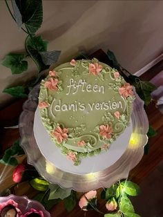 there is a cake that has been decorated with flowers and words on the top layer