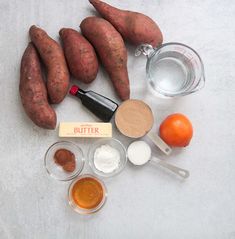 the ingredients for sweet potato casserole laid out on a white surface with oranges and spices