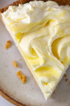 a piece of lemon cream pie sitting on top of a white plate