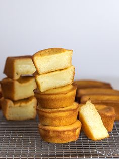 a stack of breaded pastries sitting on top of a cooling rack next to each other