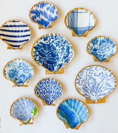 nine blue and white plates are arranged in a circle on a table top, with one being held up to the side