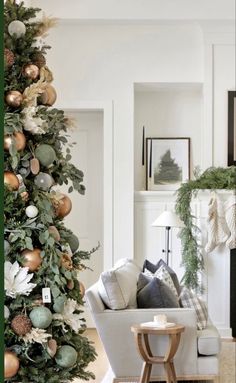 a living room with a christmas tree in the corner and other decorations on the wall