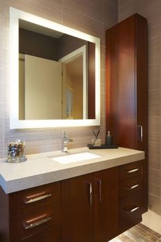 a bathroom vanity with two sinks and a large mirror