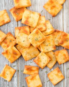 homemade crackers with herbs and seasoning on a wooden surface, ready to be eaten