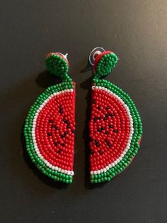 Fun 3" drop earrings hand-beaded in a watermelon slice design.  Post. A slice of summer that can be worn year-round, these hand-beaded earrings boast a bright red watermelon slice complete with green rind and black seeds.  Dangle length is 3" from post. 26-577 Red Beaded Jewelry For Summer, Summer Red Beaded Jewelry, Beaded Round Earrings For Summer, Round Beaded Summer Earrings, Green Beaded Earrings For Summer Beach, Summer Casual Jewelry With Fruit Design, Casual Summer Jewelry With Fruit Design, Summer Fruit Design Drop Earrings, Summer Red Earrings With Colorful Beads