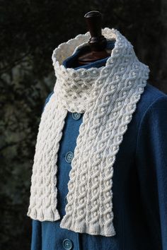 a white knitted scarf on top of a mannequin