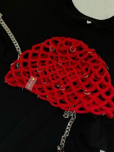 a red piece of clothing with chains attached to it