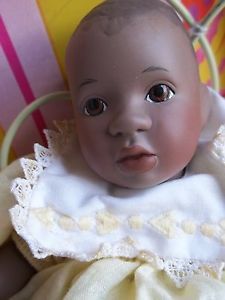 an old baby doll is sitting in a chair