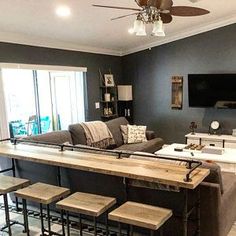 a living room filled with furniture and a flat screen tv mounted to the side of a wall