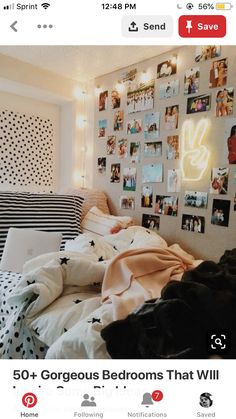 an unmade bed with many pictures on the wall and lights hanging above it in a bedroom