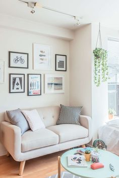 a living room filled with furniture and pictures on the wall