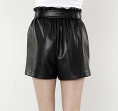 Jazz up your wardrobe with our Faux Leather Paper Bag Shorts. High-waisted and featuring a ruffled waistline cinched with a wide belt, these on-trend shorts add a touch of contemporary style to any ensemble. The paper bag design offers a playful and feminine aesthetic that contrasts with the edgy vibe of the faux leather material, giving you a unique piece that makes a defiantly bold statement. Faux leather Paper Bag waist Belted Available in Black and Camel Dry Clean Polyurethane Final Sale Ite Chic Shorts With Elastic Waistband, Trendy Belted Shorts, Chic Shorts With Elastic Waistband For Night Out, Chic Night Out Shorts With Elastic Waistband, Summer Bottoms With Belt For Night Out, Chic Going Out Shorts With Belt Loops, Spring Night Out Bottoms With Paperbag Waist, Spring Paperbag Waist Bottoms For Night Out, Summer Night Out Bottoms With Belt