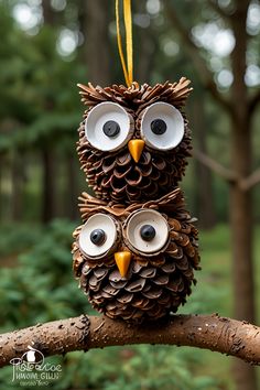 an owl made out of pine cones sitting on top of a tree branch