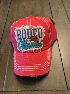 Rodeo Mama- In Texas this cap is the perfect year-round fashion accessory! Hat Details: 100% Cotton Distressed Cap Applique with Embroidered Trim, Saying, and Star Design May have embroidered Saying on Back Contrast Stitching & Button Top Adjustable Velcro Closure Pre-Curved Visor Washed Details for Vintage Look One Size Fits Most Mama Hat, Distressed Cap, Wardrobe Designs, Embroidered Trim, Teal And Pink, Star Design, Button Top, Star Designs, Contrast Stitch