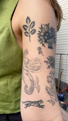 a woman's arm with various tattoos on it