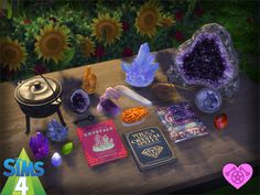 an assortment of crystals and books on a table with sunflowers in the background