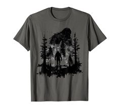 a t - shirt with the silhouette of a man walking through a forest