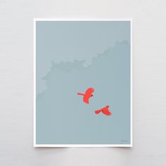 two red birds flying in the sky on a blue and gray background with white border