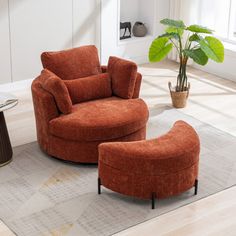 an orange chair and ottoman in a living room with a potted plant on the floor