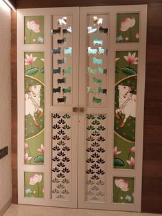 an intricately designed door in the corner of a room with flowers and leaves painted on it