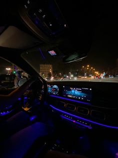 the interior of a car at night with blue lights