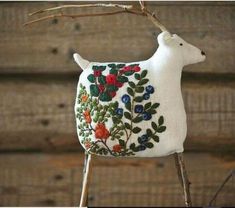 a small white sheep sitting on top of a wooden table