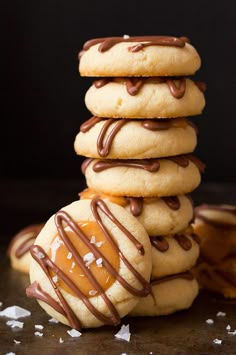 a stack of cookies with chocolate drizzled on top