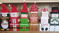 christmas decorations made out of cardboard boxes on a kitchen counter with santa hats and snowmen