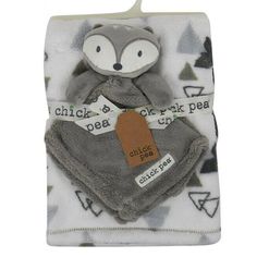 a gray and white blanket with a fox on it's back, next to a tag