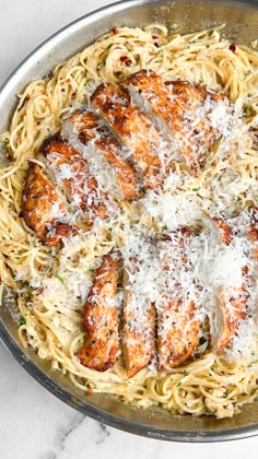 chicken parmesan pasta in a skillet on a marble counter top