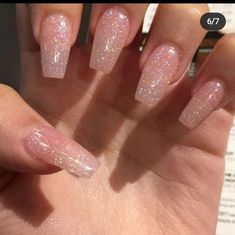 someone is holding up their hand with some pink glitter on it and there are two fingers in the foreground