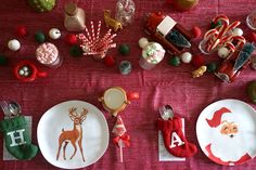 a table set for christmas with plates and candy canes